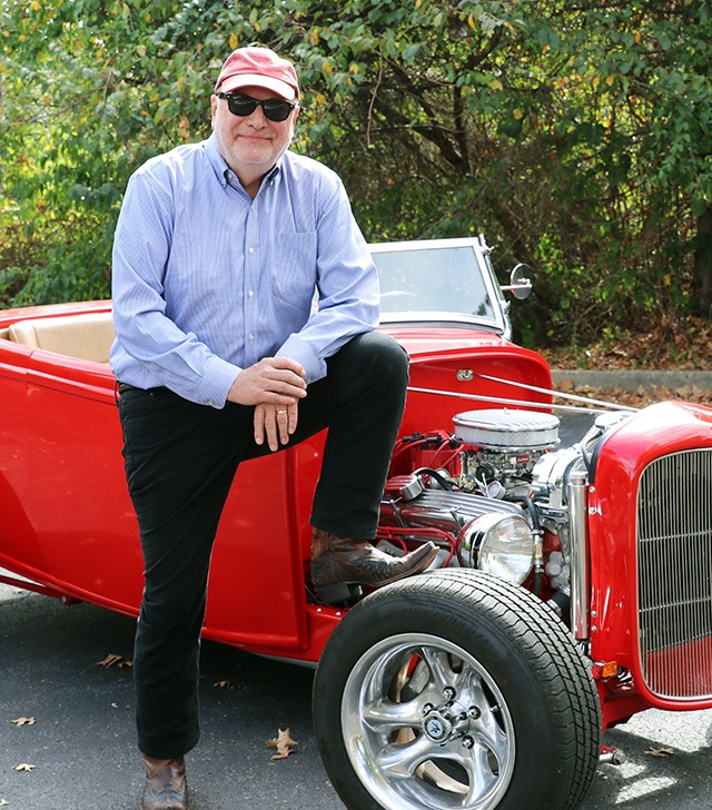 Lee standing with car